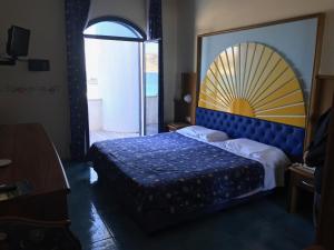 Postel nebo postele na pokoji v ubytování Sporting Baia Hotel