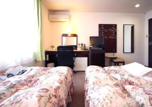 Postel nebo postele na pokoji v ubytování Royal Inn Shinyamaguchi Ekimae