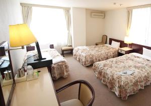 Postel nebo postele na pokoji v ubytování Royal Inn Shinyamaguchi Ekimae