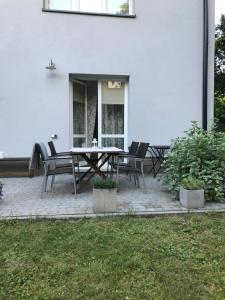a patio with a table and chairs in front of a house at cdn Pokoje in Lublin