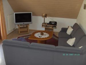 a living room with a couch and a tv at Moselblick in Sankt Aldegund