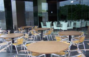 un grupo de mesas y sillas en un edificio en Grand Asia Hotel Jakarta, en Yakarta