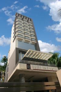 a tall building with a lot of windows at Grand Asia Hotel Jakarta in Jakarta