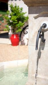 a water fountain with water coming out of it at Les Pins de l'Escalet in Ramatuelle