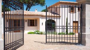 a gate in front of a house at Les Pins de l'Escalet in Ramatuelle
