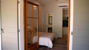 a bedroom with a bed and a sliding glass door at Les Pins de l'Escalet in Ramatuelle