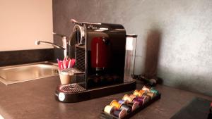 a coffee maker sitting on a counter next to a sink at Les Pins de l'Escalet in Ramatuelle