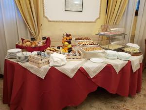 a table with a bunch of food on it at Hotel Villa Rosa in Rome