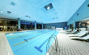a large swimming pool in a large building at Hotel Marinela Sofia in Sofia