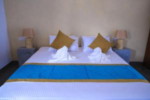 Postel nebo postele na pokoji v ubytování Hotel Star White - Negombo