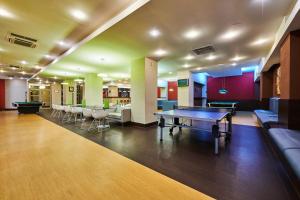 a large room with a ping pong table in it at Hotel Clermont in Covasna