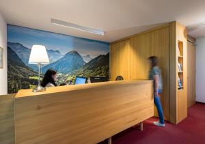 a person standing at a desk in an office at Appartementhaus Egga in Brand