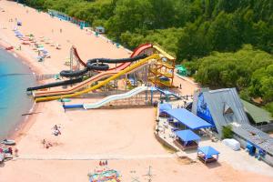 an amusement park on a beach with a roller coaster at Отель Мармелад Иссык-куль in Bosteri +27 photos