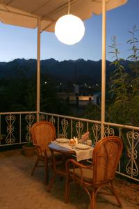a table and chairs on a balcony with a view at Отель Мармелад Иссык-куль in Bosteri