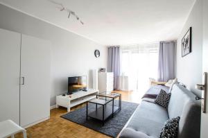 a living room with a couch and a tv at Stanisława Dubois 29, Wrocław in Wrocław