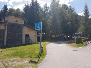 a parking lot with a sign on the side of the road at Casa Alpina Dobbiaco in Dobbiaco