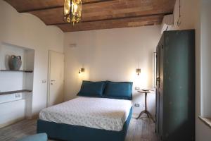 a bedroom with a bed with blue pillows at Casa Del Principe in Gambassi Terme