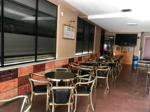 a row of tables and chairs in a restaurant at Hostal Puerta La Villa in Tordesillas