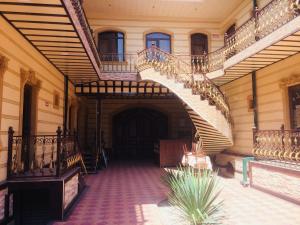 an empty hallway with a spiral staircase in a building at Hotel Shahram Plus Sh in Samarkand