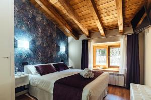 a bedroom with a bed with a teddy bear on it at Hotel Rural Pinares de Soria in Molinos de Duero