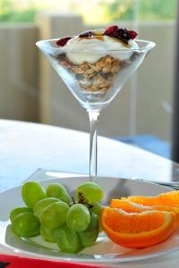 a dessert in a martini glass on a plate with fruit at Marine 5 Boutique Hotel in Gansbaai