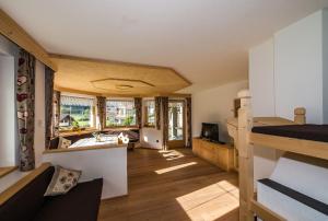 a room with a kitchen and a living room at Alpenappart in Cadipietra