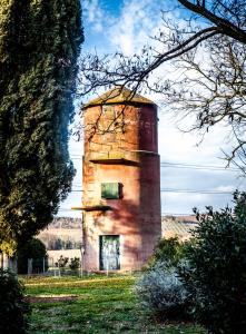 uma velha torre de tijolos no meio de um campo em Tenuta di Paganico em Paganico