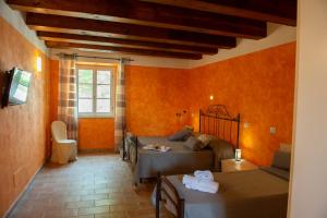 a living room with two beds and a couch at Tenuta Villa Colle Sereno in Montemarciano