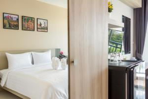 Postel nebo postele na pokoji v ubytování Evergreen Suite Hotel