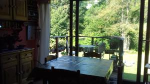 a table in a kitchen with a view of a patio at Il pettirosso di Giusvalla in Giusvalla +44 photos