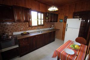 a kitchen with a table with a bowl of fruit on it at Katomeris Beach House in Roda