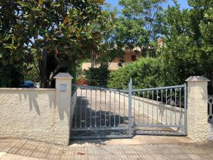 a metal gate in front of a house at Brezza di Mare in Torre Canne