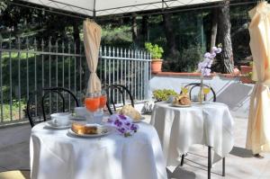 two tables with white table cloths and food on them at B&B Peschici Rooms in Peschici