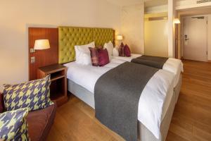 Letto o letti in una camera di Waldhotel Stuttgart