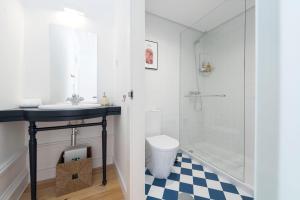 a bathroom with a sink and a shower at Tripas-Coração, São Bento Apartments in Porto