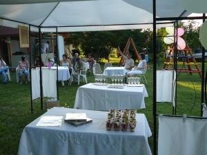 a group of people sitting at tables under a tent at Zora Camping - Bungalows in Obzor