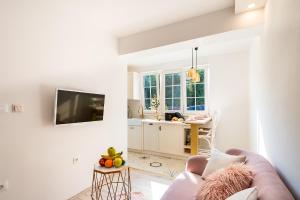 a living room with a couch and a table with fruits at Apartments Mediteraneo in Vrsar