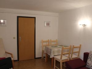 a room with a table and chairs and a door at Charming Apartment in Kr pelin with Barbecue in Kröpelin