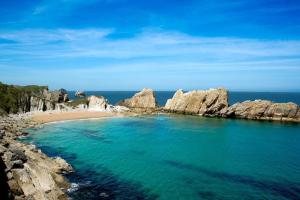a view of a beach with rocks and the ocean at Hotel Costa San Juan De La Canal in Soto de la Marina +15 photos