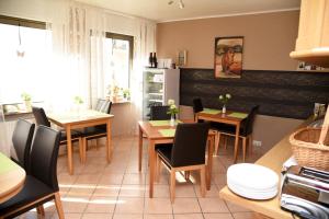 a kitchen and dining room with tables and chairs at Pension Heib in Cochem