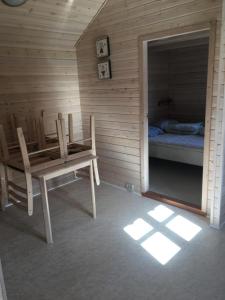 a room with a table and a chair and a bed at Vejers Family Camping & Cottages in Vejers Strand