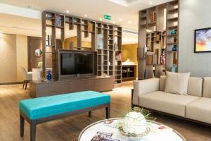 a living room with a couch and a tv at Radisson Blu Hotel, Jeddah Corniche in Jeddah