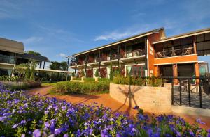 a building with purple flowers in front of it at Ma Villa Khao Yai in Mu Si