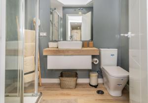 a bathroom with a sink and a toilet at Soho River in Málaga +48 photos