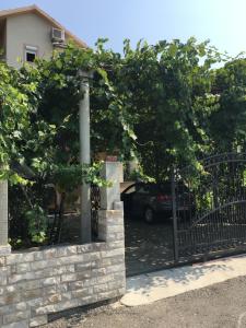 a gate with a car parked in a driveway at Makera in Tivat