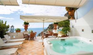 a hot tub on a patio with a view of the ocean at Palazzo Marzoli charme Resort - Small Luxury Hotel in Positano