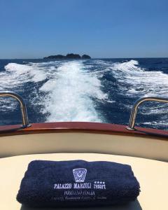 a blue towel sitting on the front of a boat at Palazzo Marzoli charme Resort - Small Luxury Hotel in Positano