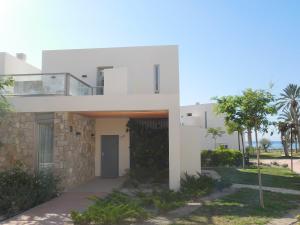 a white house with a stone wall at Vila Paradis 18 in Villajoyosa +32 photos