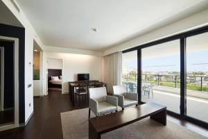 a living room with a view of a bedroom at RR Alvor Baía Resort in Alvor