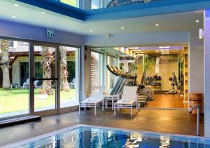 a house with a swimming pool and a gym at Luxury Sea View Apartment in Herzelia 